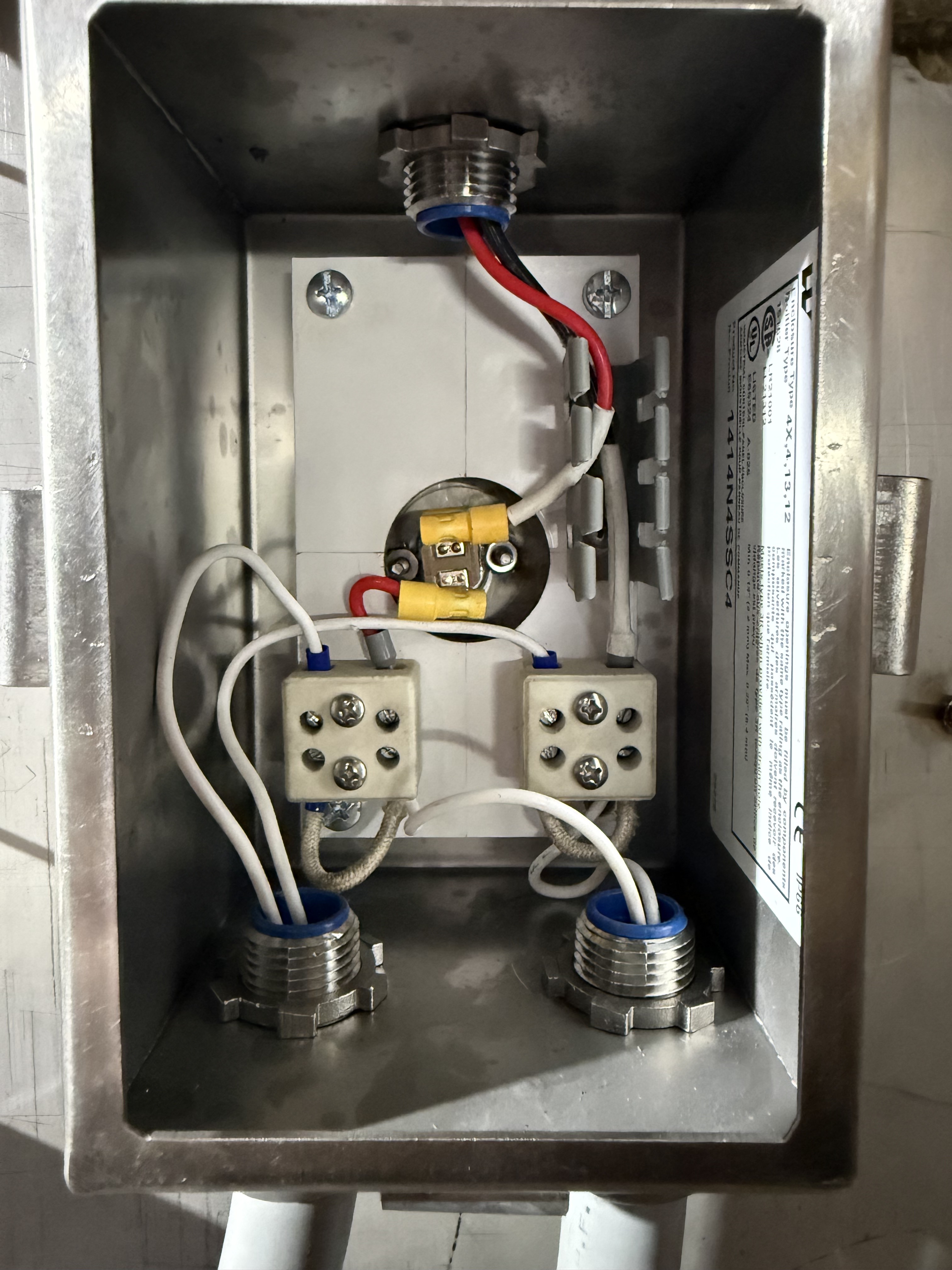 Secondary junction enclosure interior with snap disc and ceramic terminal blocks